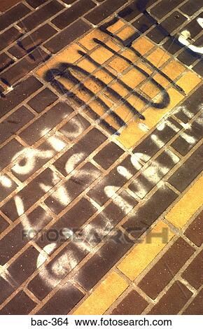 Picture - Angled View of Graffiti on Grey Brick Wall. Fotosearch