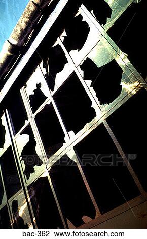 Stock Image - Closer View of Vandalised Warehouse Window. Fotosearch