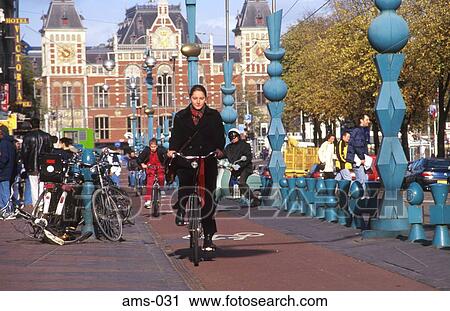 Cyclist by Central Station Amsterdam Holland View Large Photo Image Stock Image - Cyclist by Central Station Amsterdam Holland. Fotosearch