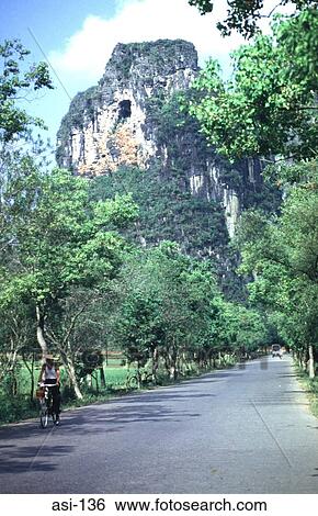Cyclist on Lane by Mountain Gulin China View Large Photo Image Stock Photograph - Cyclist on Lane by Mountain Gulin China. Fotosearch