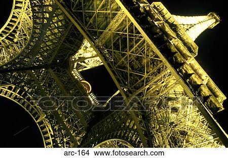 Picture - Illuminated Ironwork of Eifel Tower at Night France. Fotosearch