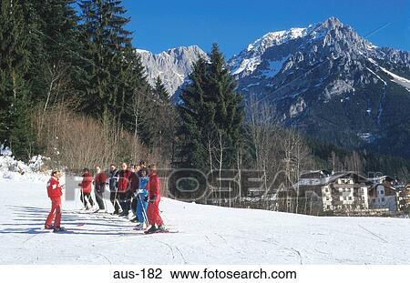 Stock Image - Line of Skiers under Instruction Austria. Fotosearch