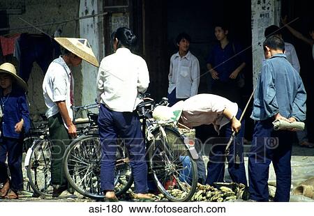 Stock Image - Local Market Traders on Bicycles China. Fotosearch