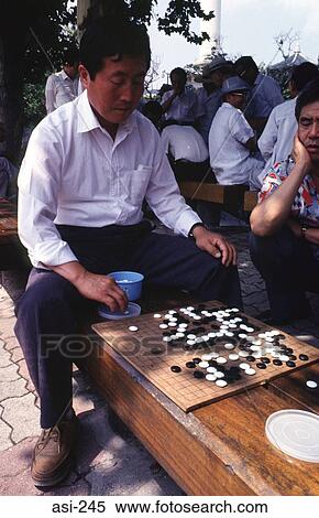 Stock Photography - Man Playing Go (a board game) Korea Asia. Fotosearch