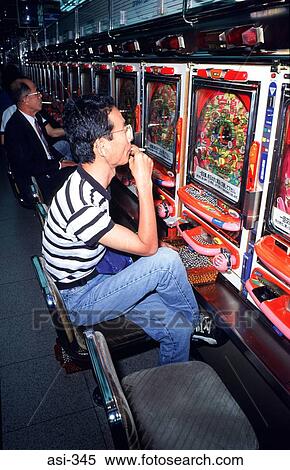 Stock Photography - Man Playing in Pachinko Arcade Tokyo Japan Asia. Fotosearch