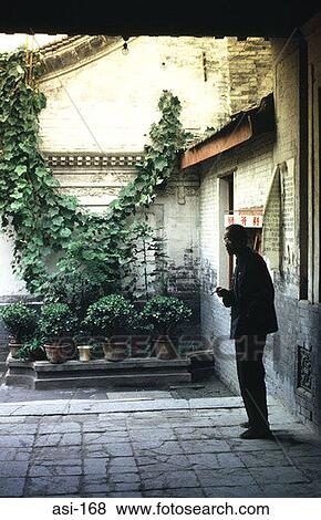 Man Smoking in Doorway Beside Planted Pots Xian View Large Photo Image Stock Photo - Man Smoking in Doorway Beside Planted Pots Xian. Fotosearch