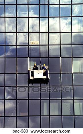 Stock Image - Men Cleaning Windows of Glass Office Block. Fotosearch