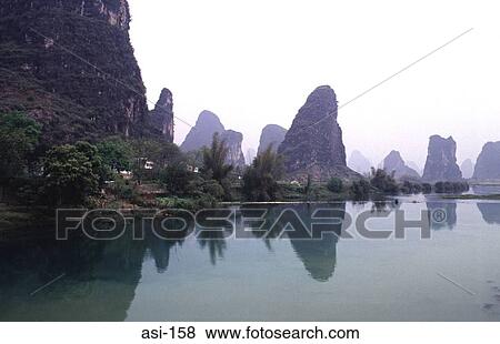 Natural Limestone Pillars Reflected in River China View Large Photo Image Stock Photo - Natural Limestone Pillars Reflected in River China. Fotosearch