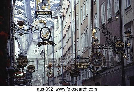 Stock Image - Ornamental Shop Signs in a Narrow Street Salzburg. Fotosearch