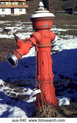 Stock Image - Red Water Hydrant in Thawing Field Austria. Fotosearch