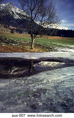 Stock Photo - Reflections in a Pool of Melted Ice Austria. Fotosearch