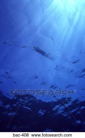 Stock Photo - Sky and Sunlight From Beneath Water. Fotosearch