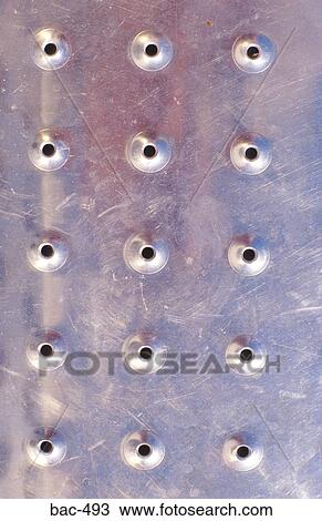 Stock Image - Steel Plate with Holes Punched in it. Fotosearch