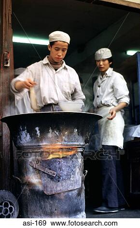 Street Kitchen With Cooks Using Open Fire Drum View Large Photo Image Stock Photo - Street Kitchen With Cooks Using Open Fire Drum. Fotosearch