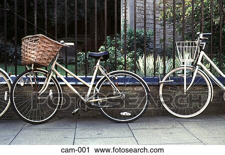 Stock Image - Bicycles Chained to Iron Railings Cambridge UK. Fotosearch