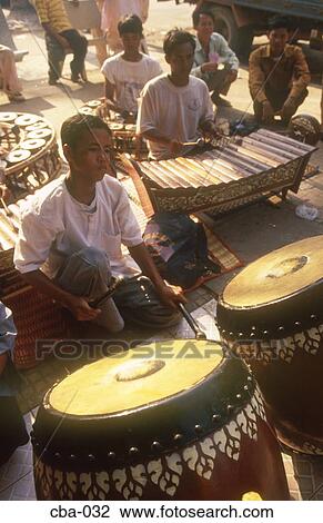 Stock Image - Boys Playing Traditional Instruments Phnom Penh Cambodia. Fotosearch