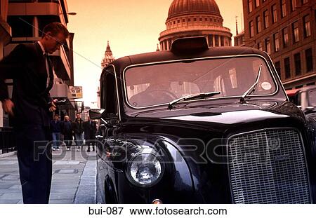 Businessman Paying Fare Outside Taxi London UK View Large Photo Image Stock Photo - Businessman Paying Fare Outside Taxi London UK. Fotosearch
