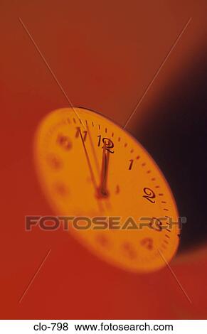 Stock Photo - Close Up of Clock Dial in Red Light. Fotosearch