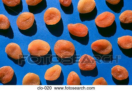 Dried Apricots against a Blue Background View Large Photo Image Stock Image - Dried Apricots against a Blue Background. Fotosearch