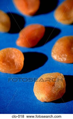 Stock Photo - Dried Apricots against a Blue Background. Fotosearch