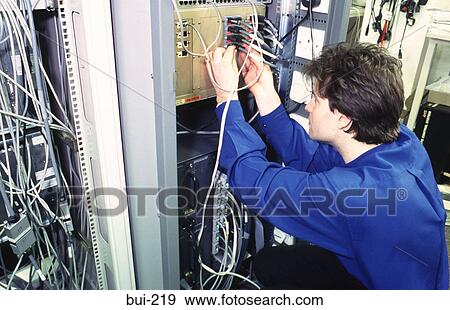 Engineer Working on Computer Network Connections UK View Large Photo Image Stock Photo - Engineer Working on Computer Network Connections UK. Fotosearch