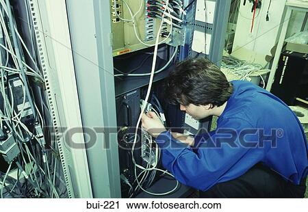 Engineer Working on Network Server Cabinet UK View Large Photo Image Stock Image - Engineer Working on Network Server Cabinet UK. Fotosearch