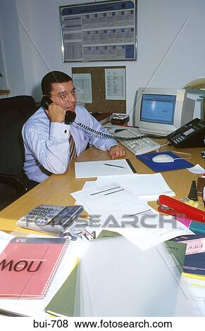 Executive at Desk Answering Telephone Call View Large Photo Image Stock Photo - Executive at Desk Answering Telephone Call. Fotosearch
