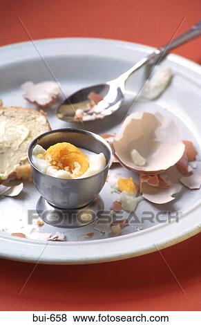 Stock Photo - Half Eaten Boiled Egg in Egg-Cup. Fotosearch