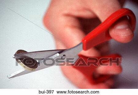 Hand Cutting Pound Coin With Scissors View Large Photo Image Stock Photo - Hand Cutting Pound Coin With Scissors. Fotosearch