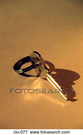 Stock Photo - Key on a Yellow Background. Fotosearch