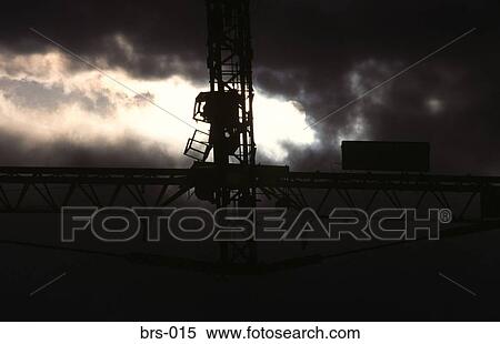 Stock Photography - Large Crane Silhouetted Against Stormy Sky UK. Fotosearch