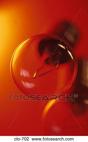 Light Bulb against Orange Background View Large Photo Image Stock Image - Light Bulb against Orange Background. Fotosearch