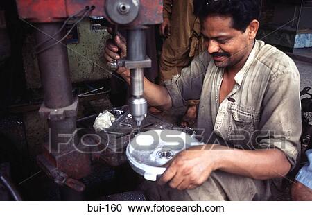 Machine Tool Operator Drilling a Metal Disc View Large Photo Image Stock Image - Machine Tool Operator Drilling a Metal Disc. Fotosearch