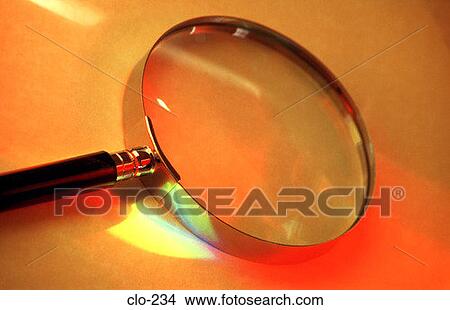 Picture - Magnifying Glass Illuminated by Coloured Light. Fotosearch