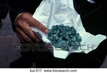 Stock Photo - Man holding Uncut Emeralds Colombia. Fotosearch