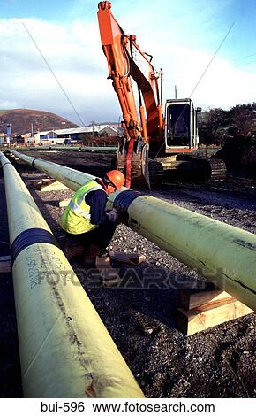 Stock Photograph - Man Joining Plastic Gas Pipes Wales UK. Fotosearch