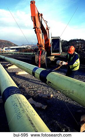 Stock Photography - Man Joining Plastic Gas Pipes Wales UK. Fotosearch