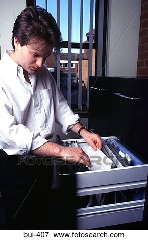 Man Using Filing Cabinet View Large Photo Image Stock Photo - Man Using Filing Cabinet. Fotosearch