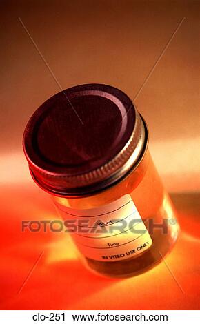 Stock Image - Medical Sample Jar under Coloured Light. Fotosearch
