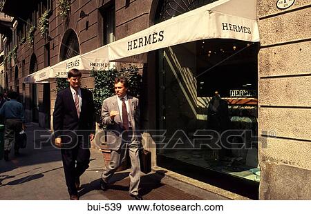 Men Walking past Shop in Milan Italy View Large Photo Image Stock Photo - Men Walking past Shop in Milan Italy. Fotosearch