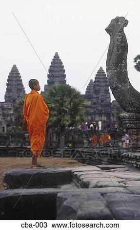 Stock Image - Monk in Saffron Robes at Angkor Wat Siem Reap Cambodia. Fotosearch