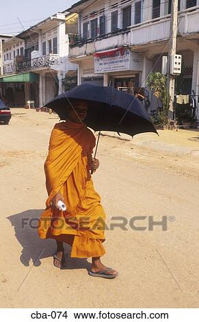 Picture - Monk in Saffron Robes with Umbrella Siem Reap Cambodia. Fotosearch
