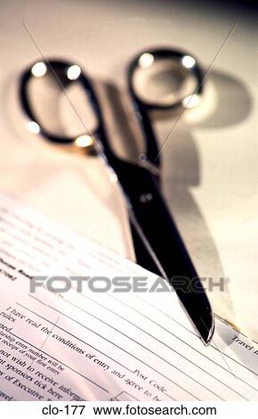 Stock Photo - Pair of Scissors Cutting Form out of Printed Paper. Fotosearch