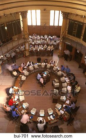 Stock Image - People Sitting at Computers around Circular Desk. Fotosearch