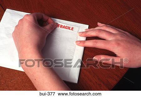 Person Labelling Envelope as 'Fragile' View Large Photo Image Stock Photo - Person Labelling Envelope as 'Fragile'. Fotosearch