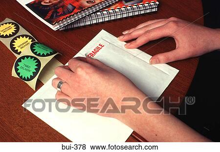 Person Labelling Envelope as 'Fragile' View Large Photo Image Stock Photo - Person Labelling Envelope as 'Fragile'. Fotosearch