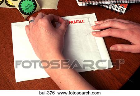 Person Labelling Envelope as 'Fragile' View Large Photo Image Stock Photograph - Person Labelling Envelope as 'Fragile'. Fotosearch