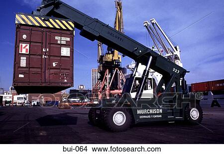 Small Crane Unloading Containers at Dock View Large Photo Image Picture - Small Crane Unloading Containers at Dock. Fotosearch