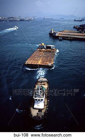 Stock Photo - Tug pulling Platform at Pusan Harbour Korea. Fotosearch