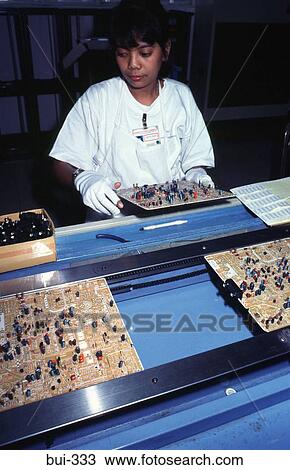 Stock Image - Woman Working on Production Line Manila Philippines. Fotosearch